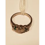 A PLATINUM, DIAMOND AND EMERALD THREE STONE RING The old cut diamond claw set between two smaller