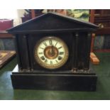 A LATE VICTORIAN BLACK MARBLE CLOCK Of architectural form with chiming movement.