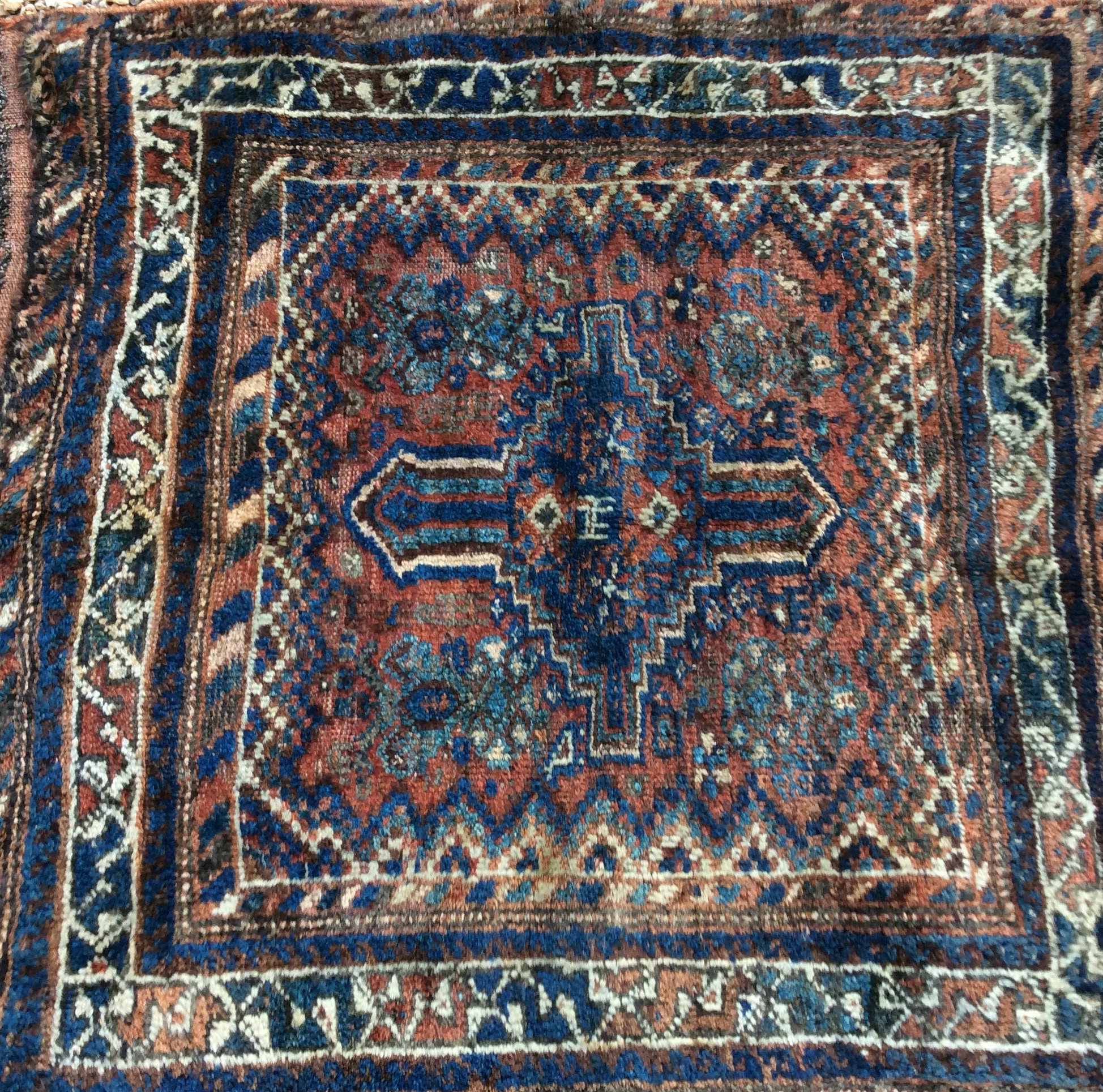 FOUR ANTIQUE PERSIAN RUGS To include one having a red field, with a geometric design and a black - Image 3 of 4