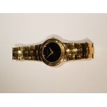 GUCCI, 3300.2.L, A LADIES' GOLD PLATED WRISTWATCH With a black face, on an integral strap. NS32