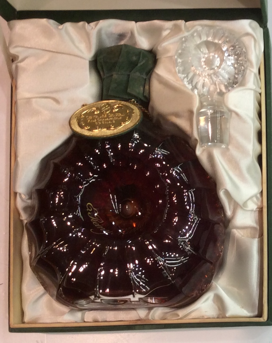 REMY MARTIN, A SCALLOP FORM BOTTLE OF CRISTAL With gilt and green velvet label, retaining original