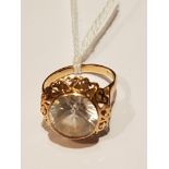 A 9CT ROSE GOLD AND WHITE GEMSTONE DRESS RING The large round cut white gemstone collet set, to a