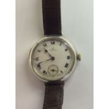 OMEGA, A GENTLEMEN'S VINTAGE SILVER WRISTWATCH Having a circular cream dial, Roman numerals and