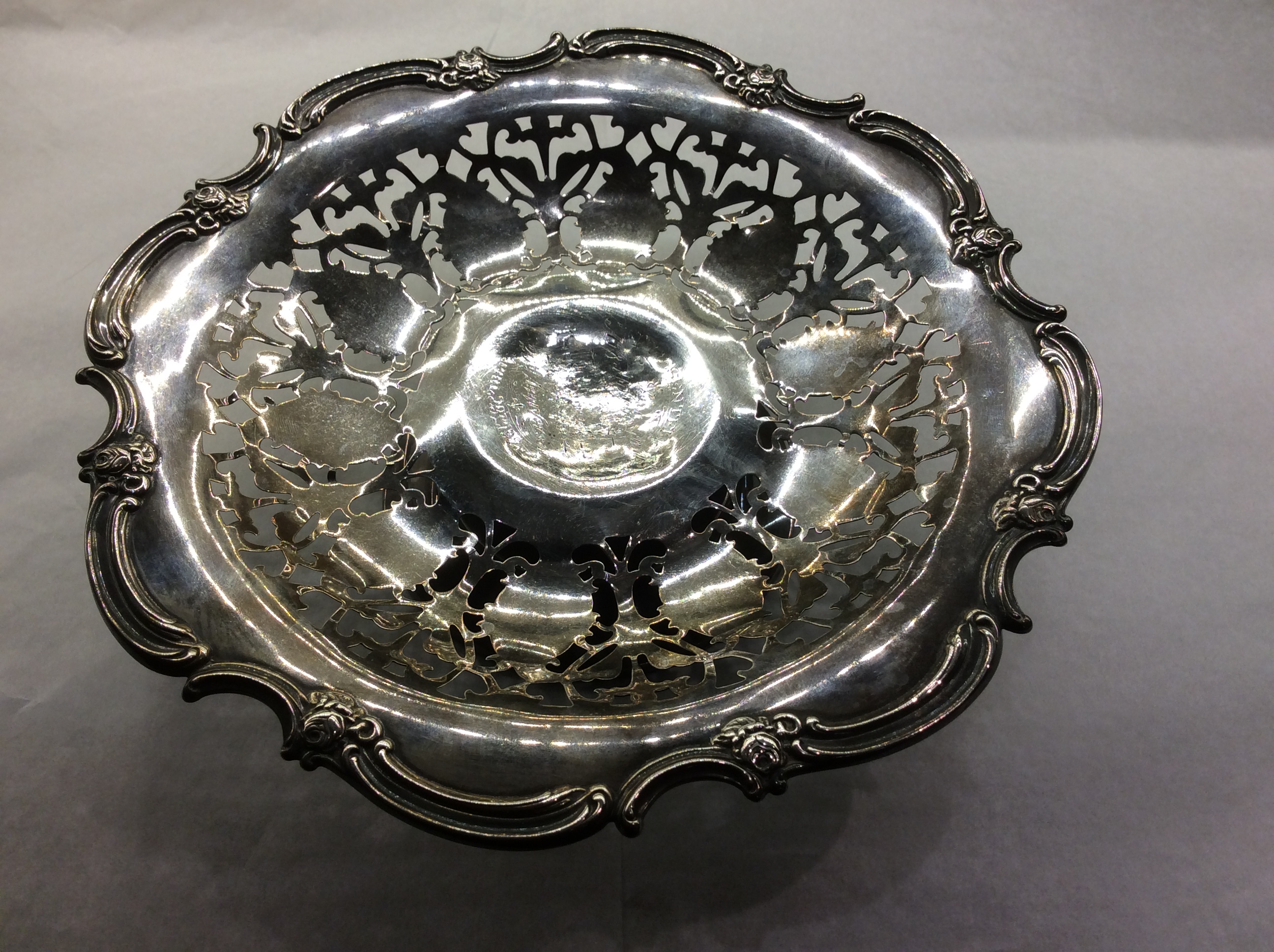 AN EARLY 20TH CENTURY STERLING SILVER TAZZA/DISH Having a scalloped edge with scrolls and flowers,