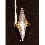 A 14CT GOLD AND DICHROIC GEMSTONE DRESS/COCKTAIL RING The elongated marquis cut pale blue topaz claw