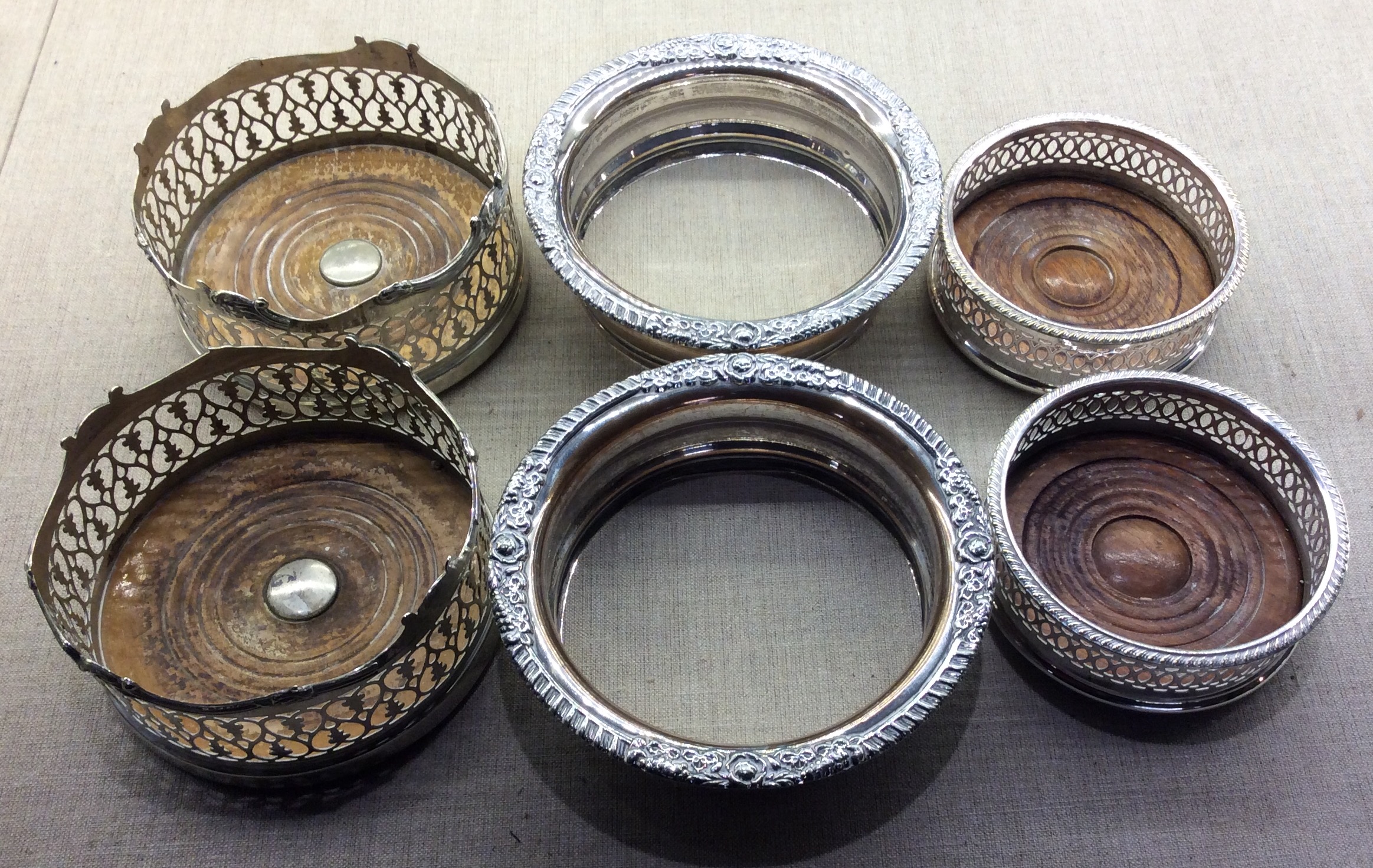 WITHDRAWN!!! THREE PAIRS OF EARLY 20TH CENTURY SILVER PLATED WINE COASTERS To include two pairs with