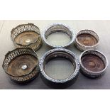 WITHDRAWN!!! THREE PAIRS OF EARLY 20TH CENTURY SILVER PLATED WINE COASTERS To include two pairs with