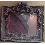 A VINTAGE GILT FRAMED MIRROR With theatrical applied decoration, including ceramic roses, old paste,