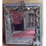 A VINTAGE GILT FRAMED MIRROR With theatrical applied decoration, including pierced metal mounts, O