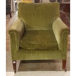 A LATE VICTORIAN EASY ARMCHAIR Upholstered in a green velvet, raised on square tapering legs on