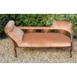 AN EDWARDIAN MAHOGANY AND MARQUETRY INLAID CHAISE LOUNGE Upholstered in a peach velvet.