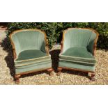 A PAIR OF WALNUT FRAMED TUB ARMCHAIRS In green velvet upholstery, the squat cabriole legs with