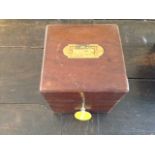 A 19TH CENTURY MAHOGANY CASED BRASS AND CUT GLASS DECANTER BOX Holding four square cut bottles, with