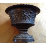 A 20TH CENTURY BRONZED CAMPANA JARDINIÈRE Heavily embossed with classical putti at play, the