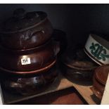 A COLLECTION OF VINTAGE STONEWARE CIRCULAR GRADUATING CASSEROLE DISHES.