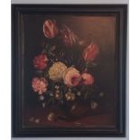 A 20TH CENTURY OIL ON BOARD Still life, a vase of pink, red and white tulips, in an ebonised