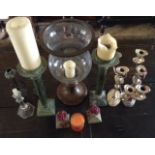 A COLLECTION OF CANDLESTICKS AND CANDLEABRAS To include a large glass dome, on a painted metal base,