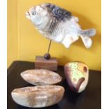A TAXIDERMY PIRANHA On a wooden stand, together with a fossilized fish, set in sandstone, along with