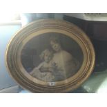 A LATE 19TH CENTURY OVAL SEPIA PHOTOGRAPH Of a mother and child, dressed in fine shawls and