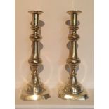 A LARGE PAIR OF LATE GEORGIAN POLISHED BRASS CANDLESTICKS. (35cm)