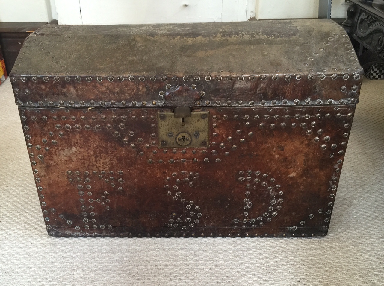 A 19TH CENTURY LEATHER BOUND DOME TOP CHEST With brass stud work decoration, bearing initials 'F.S.