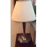 AN ART DECO SILVER PLATED LAMP Of tapered geometric design, with bulbous head and octagonal base,