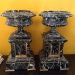 A PAIR OF 19TH CENTURY BLACK MARBLE TAZZA/GARNITURES The circular dishes set on a rectangular