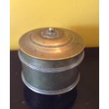 AN EARLY 20TH CENTURY BRASS TIBETAN SCROLL BOX Of cylindrical shape, with a floral finial. (approx d