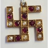 AN EARLY 20TH CENTURY 9CT GOLD, RUBY AND SEED PEARL PENDANT Having eight round cut rubies and nine