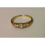 AN EARLY 20TH CENTURY 9CT GOLD, OPAL AND DIAMOND RING The three graduated cabouchon opals divided by