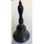 AN ANTIQUE BRONZE CHURCH BELL With ebony handle. (h 28.6cm x d 13.9cm) Condition: wood screw through