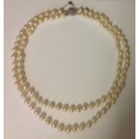 A DOUBLE STRING CULTURED PEARL NECKLACE The knotted double string of nine uniform 7.5mm cultured