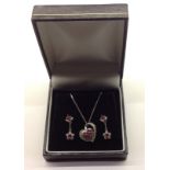 A 9CT WHITE GOLD AND RUBY SUITE OF PENDANT ON CHAIN AND DROP EARRINGS Pendant stamped '9k' and chain
