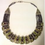 A SILVER AND MULTI GEMSTONE COLLAR NECKLACE Comprising thirteen tapering rectangular silver