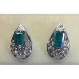 A PAIR OF 18CT WHITE GOLD, EMERALD AND DIAMOND STUD EARRINGS Each earrings comprises a rectangular