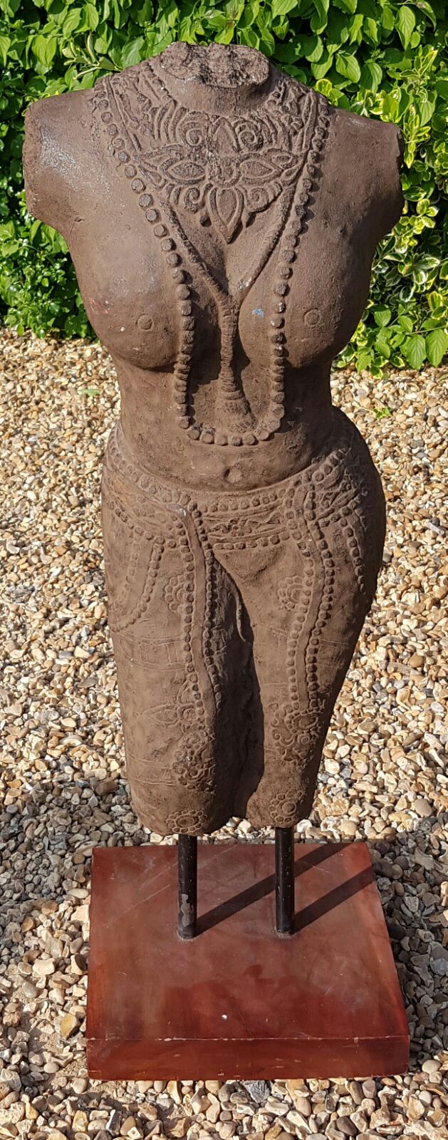 A SOUTHERN INDIAN CARVED STONE FEMALE TORSO On exhibition display stand.