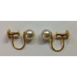 A PAIR OF VINTAGE 9CT GOLD AND CULTURED PEARL EARRINGS With screw backs, stamped '9ct'. (pearl