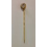 AN 18CT GOLD AND DIAMOND STICK PIN The plain 18ct gold pin claw set to the top with a pear shaped