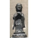 A HAN DYNASTY CHINESE BRONZE STATUE Of a monk, raised on a museum perspex base. (19cm excluding