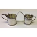 TWO EARLY 20TH CENTURY HALLMARKED SILVER CIRCULAR SECTION SALTS AND SPOONS The larger bears