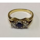 A LATE 20TH CENTURY 18CT GOLD, SAPPHIRE AND DIAMOND RING The single round cut sapphire, flanked by
