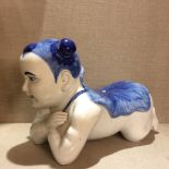 A LARGE CHINESE BLUE AND WHITE PORCELAIN HEADREST On a kneeling child, wearing a lotus shape