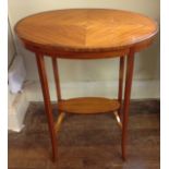 A SATINWOOD OVAL OCCASIONAL TABLE With quarter veneers to top, having crossbanded and string