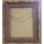 A LATE 19TH CENTURY GILT GESSO PICTURE FRAME Of rectangular form, with ornate scrolling and