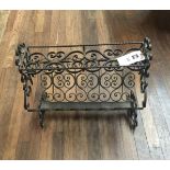 AN EARLY 20TH CENTURY DECORATIVE WROUGHT IRON CANTERBURY.