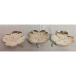 A SET OF THREE SILVER CLOVER FORM DISHES With stalk handle, bearing 'NE' monogram to centre and