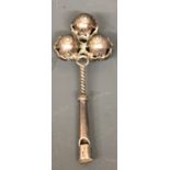 A SMALL ANTIQUE SILVER CHILD'S RATTLE Having three pierced rattling spheres, with concentric