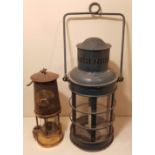 THREE EARLY 20TH CENTURY IRON LANTERNS Along with a miners brass tilly lamp.