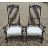 A PAIR OF 17TH CENTURY WALNUT OPEN ARMCHAIRS With carved and pierced top cartouche, above turned and