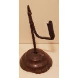 AN 18TH CENTURY IRON TABLE RUSHLIGHT AND CANDLE SOCKET The spiral twist stem and bracket arm, set on